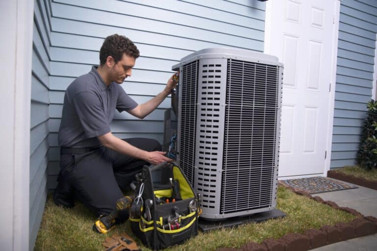 HVAC Technician servicing an air conditioning unit outside